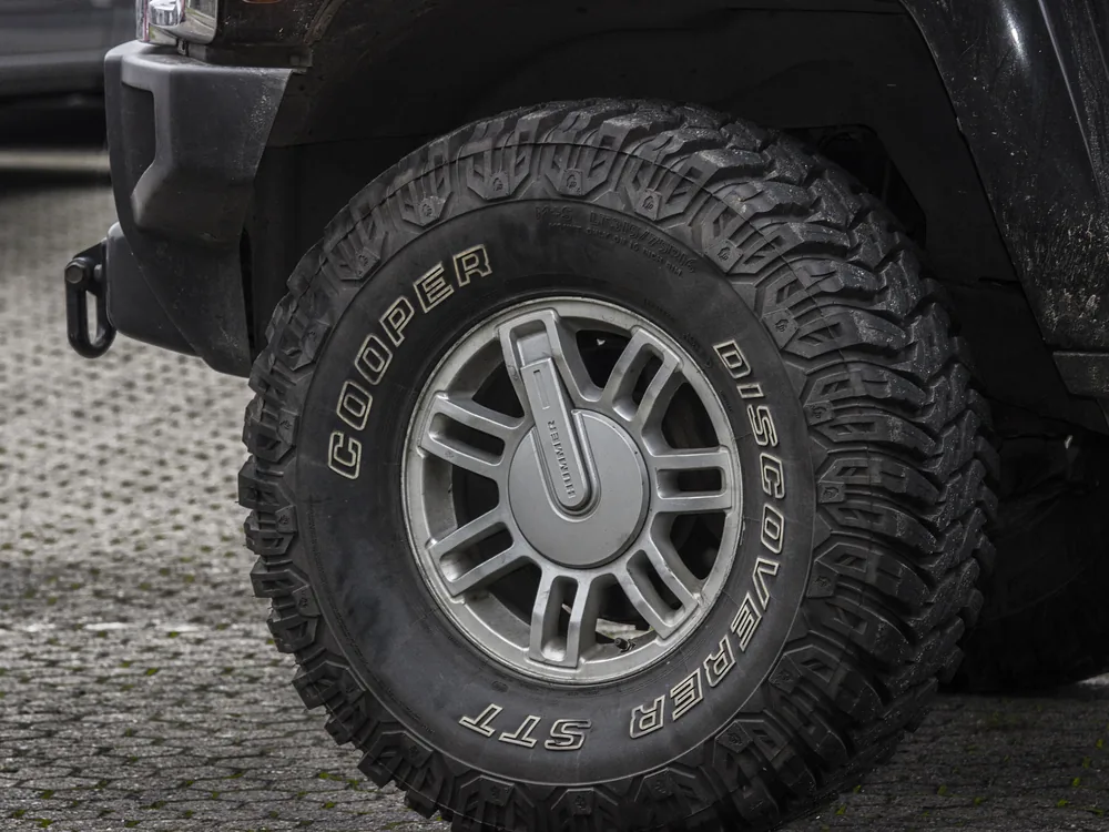 A single car tire shown from the side and tread